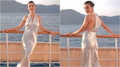 Amy Jackson was the picture of elegance in a white halter-neck satin gown from Saint Laurent for her wedding festivities. She completed the look with a diamond necklace, bold red lips and a sleek bun. (Instagram) Amy Jackson was the picture of elegance in a white halter-neck satin gown from Saint Laurent for her wedding festivities. She completed the look with a diamond necklace, bold red lips and a sleek bun. (Instagram)