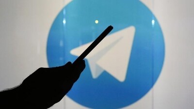 A man is seen as a silhouette as he checks a mobile device whilst standing against an illuminated wall bearing Telegram's logo in this arranged photograph in London. (Bloomberg) A man is seen as a silhouette as he checks a mobile device whilst standing against an illuminated wall bearing Telegram's logo in this arranged photograph in London. (Bloomberg)