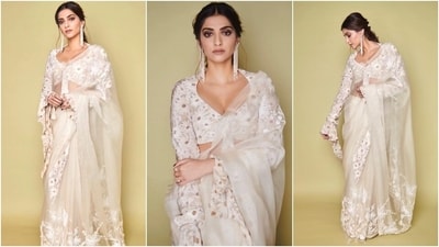 Here, Sonam wears a floral printed cropped top with an embroidered organza saree. The daisy-printed blouse features a plunging leaf-cut neckline, a front knot design, and full-length cascading bell sleeves. The blouse added a retro touch to the ensemble. (Instagram) Here, Sonam wears a floral printed cropped top with an embroidered organza saree. The daisy-printed blouse features a plunging leaf-cut neckline, a front knot design, and full-length cascading bell sleeves. The blouse added a retro touch to the ensemble. (Instagram)
