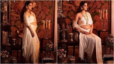 For her pregnancy photoshoot, Sonam proudly displayed her baby bump in a regal ensemble designed by Abu Jani Sandeep Khosla. The actor wore an ivory saree, the drapes of which were romantically wrapped around her body. The pallu was delicately placed on one shoulder, giving a peek at the stylish strapless blouse. (Instagram) For her pregnancy photoshoot, Sonam proudly displayed her baby bump in a regal ensemble designed by Abu Jani Sandeep Khosla. The actor wore an ivory saree, the drapes of which were romantically wrapped around her body. The pallu was delicately placed on one shoulder, giving a peek at the stylish strapless blouse. (Instagram)