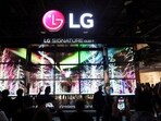 Attendees watch a display of LG Signature T transparent 4K OLED televisions at CES 2024, an annual consumer electronics trade show, in Las Vegas, Nevada.