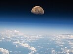 The image shows the moon setting over the Pacific. NASA astronaut Matthew Dominick captured the photo. The image shows the moon setting over the Pacific. NASA astronaut Matthew Dominick captured the photo.
