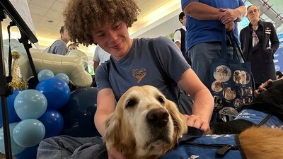 A passenger pets a therapy dog, a member of the Wagging Tails Brigade. Members of the Wagging Tails Brigade and their volunteer handlers were honoured on Monday at Philadelphia International Airport. They have been doing their work the airport's corridors for five years greeting people and serving as therapy dogs to help conform travelers. (AP) A passenger pets a therapy dog, a member of the Wagging Tails Brigade. Members of the Wagging Tails Brigade and their volunteer handlers were honoured on Monday at Philadelphia International Airport. They have been doing their work the airport's corridors for five years greeting people and serving as therapy dogs to help conform travelers. (AP)