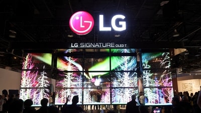 Attendees watch a display of LG Signature T transparent 4K OLED televisions at CES 2024, an annual consumer electronics trade show, in Las Vegas, Nevada. (Reuters)