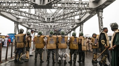 Police personnel deployed at Howrah Bridge in view of 'Nabanna Abhijan' rally called by Paschim Banga Chhatra Samaj, a students' organisation, to protest against the alleged sexual assault and murder of a trainee doctor, in Kolkata, Tuesday. (PTI) Police personnel deployed at Howrah Bridge in view of 'Nabanna Abhijan' rally called by Paschim Banga Chhatra Samaj, a students' organisation, to protest against the alleged sexual assault and murder of a trainee doctor, in Kolkata, Tuesday. (PTI)
