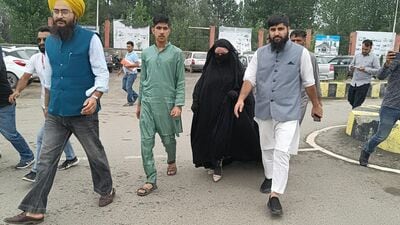 Wearing an all covering burqa, Sughra climbed a vehicle on Tuesday and cued her fellow villagers as she marched from Reban to file her father’s nomination papers. (HT Photo) Wearing an all covering burqa, Sughra climbed a vehicle on Tuesday and cued her fellow villagers as she marched from Reban to file her father’s nomination papers. (HT Photo)