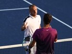 Daniel Evans of Great Britain shakes hands with Karen Khachanov of Russia after winning in five sets during their Men's Singles First Round match on Day Two of the 2024 US Open