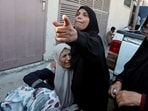 Mourners react during the funeral of Palestinians killed in Israeli strikes, amid the Israel-Hamas conflict, at Al-Aqsa Martyrs hospital in Deir Al-Balah in the central Gaza Strip.
