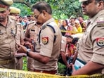 Police personnel investigate after the bodies of two girls were found hanging from a tree, at Kayamganj area in Farrukhabad on August 27, 2024. (PTI) Police personnel investigate after the bodies of two girls were found hanging from a tree, at Kayamganj area in Farrukhabad on August 27, 2024. (PTI)