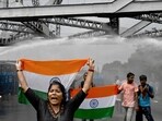 Police use water canons to disperse protesters carrying national flag as they march towards the state secretariat demanding the resignation of West Bengal chief minister Mamata Banerjee amid protests against the rape and murder of a doctor.