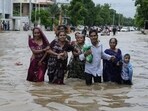 A family wades through a flooded road following heavy rainfall in Ahmedabad, Gujarat. (AP Photo) A family wades through a flooded road following heavy rainfall in Ahmedabad, Gujarat. (AP Photo)