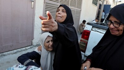 Mourners react during the funeral of Palestinians killed in Israeli strikes, amid the Israel-Hamas conflict, at Al-Aqsa Martyrs hospital in Deir Al-Balah in the central Gaza Strip. (REUTERS)