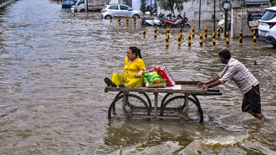 A flooded road in Vadodara on Tuesday after heavy rainfall caused waterlogging in the city (PTI Photo) (PTI) A flooded road in Vadodara on Tuesday after heavy rainfall caused waterlogging in the city (PTI Photo) (PTI)