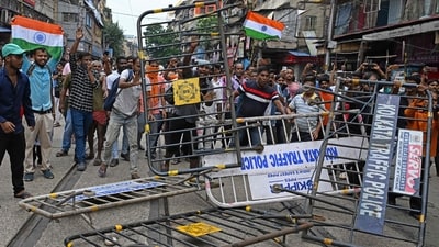 Activists wrecking barricades set up by the police during a rally on Tuesday (AFP) Activists wrecking barricades set up by the police during a rally on Tuesday (AFP)