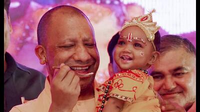 Uttar Pradesh Chief Minister Yogi Adityanath conducts 'Annaprashan' of a child during a programme in Aligarh on Wednesday. (PTI) Uttar Pradesh Chief Minister Yogi Adityanath conducts 'Annaprashan' of a child during a programme in Aligarh on Wednesday. (PTI)