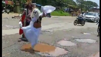 Karnataka men dress up as Yamaraja and Chitragupta to protest against potholes in Udupi, conduct long-jump race. Video Karnataka men dress up as Yamaraja and Chitragupta to protest against potholes in Udupi, conduct long-jump race. Video