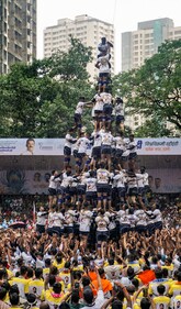 Onlookers enjoy as a seven-layer human pyramid tries to break a handi in the city (Photo: PTI) Onlookers enjoy as a seven-layer human pyramid tries to break a handi in the city (Photo: PTI)