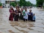 A family wades through a flooded road after heavy rain in Ahmedabad, India, Monday, Aug. 26, 2024. A family wades through a flooded road after heavy rain in Ahmedabad, India, Monday, Aug. 26, 2024.