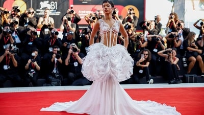 Taylor Russell, member of the jury of the Luigi De Laurentiis Venice Award for a Debut Film, nabbed a look from Chanel’s spring 1993 couture show for her red carpet appearance. Originally worn by Claudia Schiffer, the white dress features a transparent PVC corseted bodice with floral and fauna motifs over the bust. Meanwhile, the skirt - also the statement piece of the whole look - featured a cloud of sheer fabric and a dramatic train.&nbsp; (REUTERS)