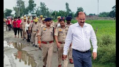 Farrukhabad DM VK Singh and SP Alok Priyadarshi reach the incident site after bodies of two girls were found hanging from a tree. (ANI Photo) Farrukhabad DM VK Singh and SP Alok Priyadarshi reach the incident site after bodies of two girls were found hanging from a tree. (ANI Photo)