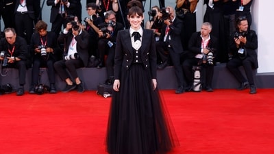 Winona Ryder wore a custom Chanel gown to the Beetlejuice Beetlejuice screening. The ensemble is inspired by a look from 2007. It features a cropped blazer, a matching waistcoat, a tailored white shirt, and a black tulle skirt. She styled the ensemble with a top knot, a bow tie, kohl-lined eyes, and minimal glam. (Vianney Le Caer/Invision/AP) Winona Ryder wore a custom Chanel gown to the Beetlejuice Beetlejuice screening. The ensemble is inspired by a look from 2007. It features a cropped blazer, a matching waistcoat, a tailored white shirt, and a black tulle skirt. She styled the ensemble with a top knot, a bow tie, kohl-lined eyes, and minimal glam. (Vianney Le Caer/Invision/AP)