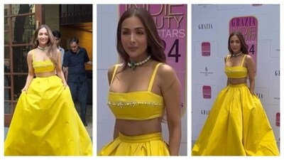 Malaika Arora radiated a desi princess vibe in her yellow ensemble. She wore a fitted yellow bralette embellished with crystals, paired with a matching high-waisted, full-length skirt that featured pockets. The skirt's silhouette was regal and elegant. Keeping her hair loose, she accessorized with a statement choker necklace adorned with a green gem at the centre. The pockets of her dress were definitely the highlight of the ensemble, and the contemporary twist on the traditional look was fascinating. (Instagram/@varindertchawla) Malaika Arora radiated a desi princess vibe in her yellow ensemble. She wore a fitted yellow bralette embellished with crystals, paired with a matching high-waisted, full-length skirt that featured pockets. The skirt's silhouette was regal and elegant. Keeping her hair loose, she accessorized with a statement choker necklace adorned with a green gem at the centre. The pockets of her dress were definitely the highlight of the ensemble, and the contemporary twist on the traditional look was fascinating. (Instagram/@varindertchawla)