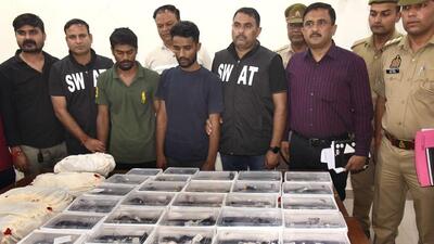 The two suspects (third and fourth from left) in custody. Police said 125 watches, valued at ₹46 lakh, were recovered. (Sakib Ali/HT Photo) The two suspects (third and fourth from left) in custody. Police said 125 watches, valued at ₹46 lakh, were recovered. (Sakib Ali/HT Photo)