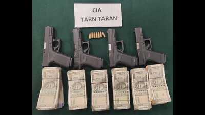 The weapons and cash recovered by the Tarn Taran police.