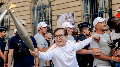 Jackie Chan carries Paralympic torch in Paris