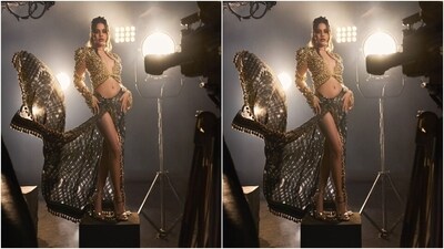 The second look, infused with the designer duo's quintessential maximal touch, featured Uorfi in a stunning skirt and blouse set. The outfit is symbolic of her creativity and bold style. While the gold jewelled blouse features diamantes, a plunging neckline, and a cropped silhouette, the skirt wrapped around her body features tassel embroidery and a front thigh-high slit.&nbsp; (Instagram)