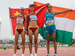 Aarti (R) poses after winning bronze