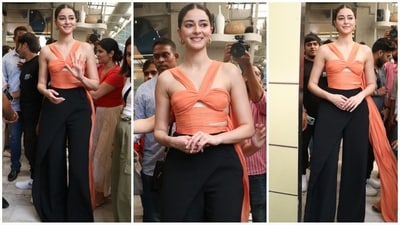 Ananya Pandey stuns in her latest Bae look, sporting an orange top with chic cut-out detailing and an extended floor-sweeping fabric. Paired with black flared pants and golden hoop earrings, she looks absolutely stylish. (Instagram) Ananya Pandey stuns in her latest Bae look, sporting an orange top with chic cut-out detailing and an extended floor-sweeping fabric. Paired with black flared pants and golden hoop earrings, she looks absolutely stylish. (Instagram)