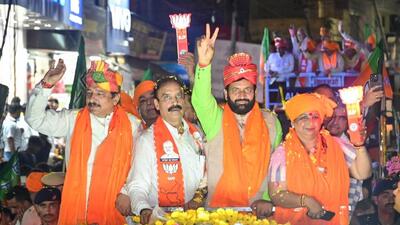 Haryana CM Nayab Singh Saini greets the supporters during a roadshow in Karnal on Friday. (HT Photo)