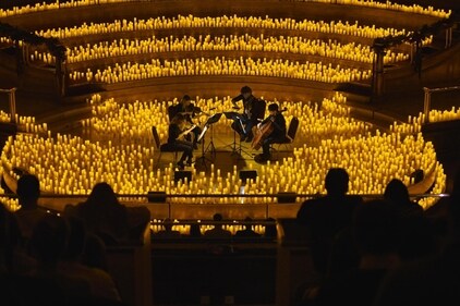 Surrounded by thousands of candles, a quartet plays Surrounded by thousands of candles, a quartet plays
