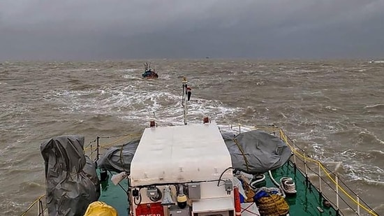 An Indian Coast Guard ship tows boat ‘Padmawati’ to safety after it drifted into the sea due to rough weather conditions off the Dwarka coast in Gujarat. (PTI Photo)