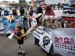 Refugees and asylum seekers, mostly from the Afghanistan's Hazara ethnic group who have been in Indonesia for about 7 to 12 years and others from Sudan, Somalia and Ethiopia, take part in a protest demanding their resettlement and basic human rights assistance in front of the United Nations High Commissioner for Refugees (UNHCR) office building in Jakarta on August 12, 2024. (Photo by Yasuyoshi CHIBA / AFP) Refugees and asylum seekers, mostly from the Afghanistan's Hazara ethnic group who have been in Indonesia for about 7 to 12 years and others from Sudan, Somalia and Ethiopia, take part in a protest demanding their resettlement and basic human rights assistance in front of the United Nations High Commissioner for Refugees (UNHCR) office building in Jakarta on August 12, 2024. (Photo by Yasuyoshi CHIBA / AFP)