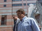Dr. Mark Chavez, right, a physician from San Diego who is charged in connection with actor Matthew Perry's death from an accidental ketamine overdose, and his attorney Matthew Binninger, leave the Roybal Federal Courthouse in Los Angeles, Friday, Aug. 30, 2024. (AP Photo/Damian Dovarganes)