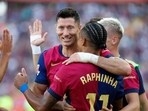 Barcelona's Raphinha, front, is congratulated after scoring his side's 4th goal during the Spanish La Liga soccer match between FC Barcelona and Valladolid