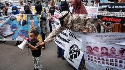 Refugees and asylum seekers, mostly from the Afghanistan's Hazara ethnic group who have been in Indonesia for about 7 to 12 years and others from Sudan, Somalia and Ethiopia, take part in a protest demanding their resettlement and basic human rights assistance in front of the United Nations High Commissioner for Refugees (UNHCR) office building in Jakarta on August 12, 2024. (Photo by Yasuyoshi CHIBA / AFP) (AFP) Refugees and asylum seekers, mostly from the Afghanistan's Hazara ethnic group who have been in Indonesia for about 7 to 12 years and others from Sudan, Somalia and Ethiopia, take part in a protest demanding their resettlement and basic human rights assistance in front of the United Nations High Commissioner for Refugees (UNHCR) office building in Jakarta on August 12, 2024. (Photo by Yasuyoshi CHIBA / AFP) (AFP)