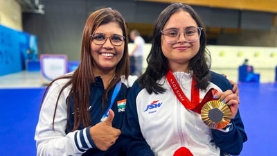 India's Avani Lekhara with her coach Suma Shirur pose for photos after winning the gold medal in the women's 10m air rifle (SH1) shooting event. (PTI) India's Avani Lekhara with her coach Suma Shirur pose for photos after winning the gold medal in the women's 10m air rifle (SH1) shooting event. (PTI)