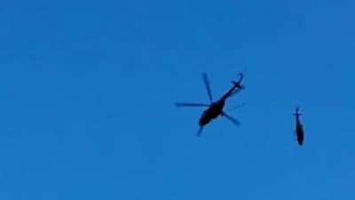 The helicopter is seen dangling mid-air before it came crashing down (PTI) The helicopter is seen dangling mid-air before it came crashing down (PTI)