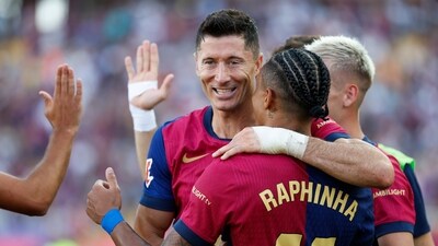 Barcelona's Raphinha, front, is congratulated after scoring his side's 4th goal during the Spanish La Liga soccer match between FC Barcelona and Valladolid (AP) Barcelona's Raphinha, front, is congratulated after scoring his side's 4th goal during the Spanish La Liga soccer match between FC Barcelona and Valladolid (AP)