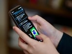A Brazilian user of the social network X, formerly Twitter, browses posts on a cell phone in Brasilia on August 31, 2024. (EVARISTO SA/AFP) A Brazilian user of the social network X, formerly Twitter, browses posts on a cell phone in Brasilia on August 31, 2024. (EVARISTO SA/AFP)