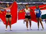 Xia Zhou of China celebrates after winning gold with silver medallist Qianqian Guo of China and bronze medallist Preethi Pal of India 