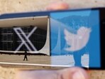 The logo of social media platform X is seen on a mobile phone next to a reflection of Brazil's Supreme Court in this illustration taken August 30, 2024, in Brasilia, Brazil. (Ueslei Marcelino/Reuters)