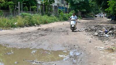 A badly damaged road near Rajput Vatika in Gurugram Sector 12A in Ward 6 on Saturday. (Parveen Kumar/HT Photo)