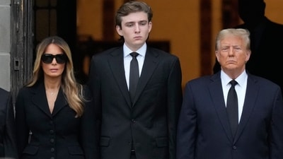 Former President Donald Trump, center right, stands with his wife Melania, second left, and their son Barron, center left, as the coffin carrying the remains of Amalija Knavs, the former first lady's mother, is carried into the Church of Bethesda-by-the-Sea for her funeral, Thursday, Jan. 18, 2024, in Palm Beach, Fla. (AP) Former President Donald Trump, center right, stands with his wife Melania, second left, and their son Barron, center left, as the coffin carrying the remains of Amalija Knavs, the former first lady's mother, is carried into the Church of Bethesda-by-the-Sea for her funeral, Thursday, Jan. 18, 2024, in Palm Beach, Fla. (AP)