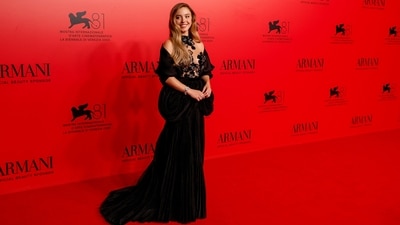 Sydney Sweeney wore a romantic black floor-length Giorgio Armani gown at an Armani Beauty event during the 81st edition of the Venice Film Festival. Her velvet gown features a sheer bust adorned with floral and sequin adornments, a pleated skirt, and a cascading train. (Joel C Ryan/Invision/AP) Sydney Sweeney wore a romantic black floor-length Giorgio Armani gown at an Armani Beauty event during the 81st edition of the Venice Film Festival. Her velvet gown features a sheer bust adorned with floral and sequin adornments, a pleated skirt, and a cascading train. (Joel C Ryan/Invision/AP)