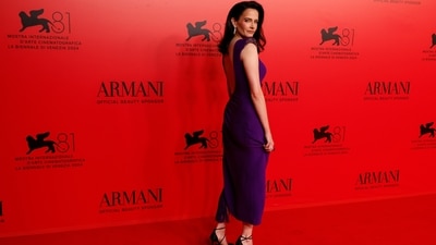 Eva Green attended the Armani Beauty event during the 81st edition of the Venice Film Festival in a backless purple dress featuring shimmering embellishments. She styled the look with loose tresses, black stilettos, diamond jewels, and striking glam. (Joel C Ryan/Invision/AP) Eva Green attended the Armani Beauty event during the 81st edition of the Venice Film Festival in a backless purple dress featuring shimmering embellishments. She styled the look with loose tresses, black stilettos, diamond jewels, and striking glam. (Joel C Ryan/Invision/AP)