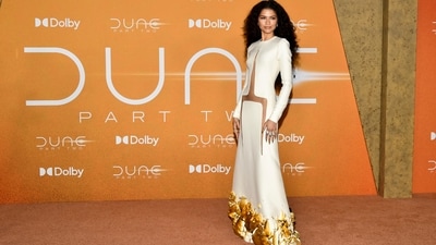 Zendaya turned heads at the Dune: Part Two premiere in a white floor-length dress with daring cut-outs and golden sculptural details. She styled her hair in cascading curls and opted for a subtle, glowy makeup look. (Evan Agostini/Invision/AP) Zendaya turned heads at the Dune: Part Two premiere in a white floor-length dress with daring cut-outs and golden sculptural details. She styled her hair in cascading curls and opted for a subtle, glowy makeup look. (Evan Agostini/Invision/AP)